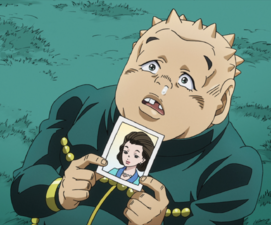 Shigechi holding a picture of his mom in the anime
