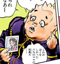 Shigechi holding a picture of his mom