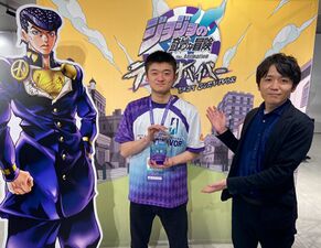 Championship Winner Yamamoto Infinity receiving his trophy from Game Producer Kazuaki Shoji