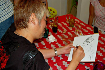 Drawing his sketch, for a fan (Sep 16, 2015)[52]