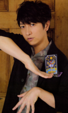 Daisuke Ono holding a tarot card
