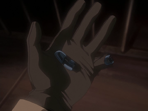 Holding his prosthetic finger that Star Platinum detached and Jotaro flung to him