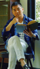 Miyake posing with a book