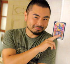 Komatsu holding his character's tarot